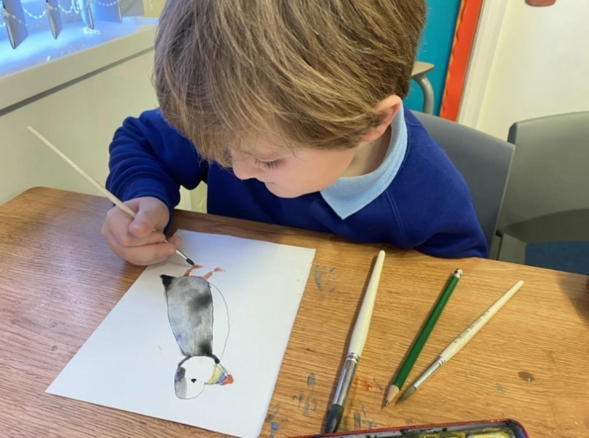 Child painting a puffin