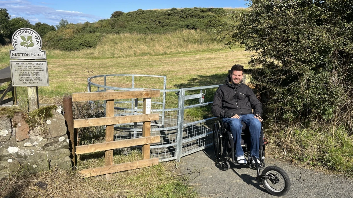 Person using a wheelchair on the path at Newton 