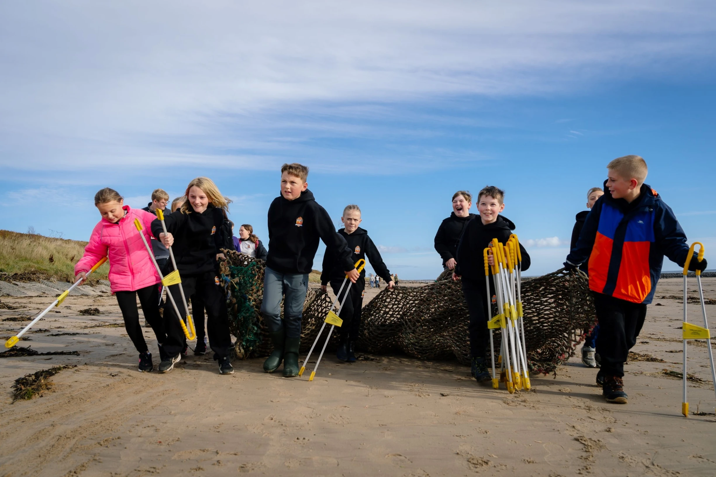 Children picking up litter on the beach