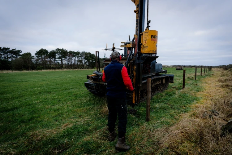 farmer building a fence